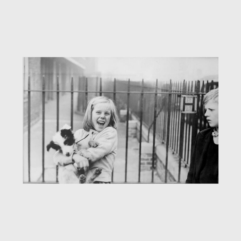 Girl holding a dog, 1957